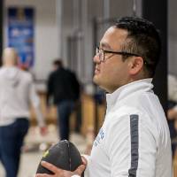 An alumnus holding the football at the Fowling Fun Event